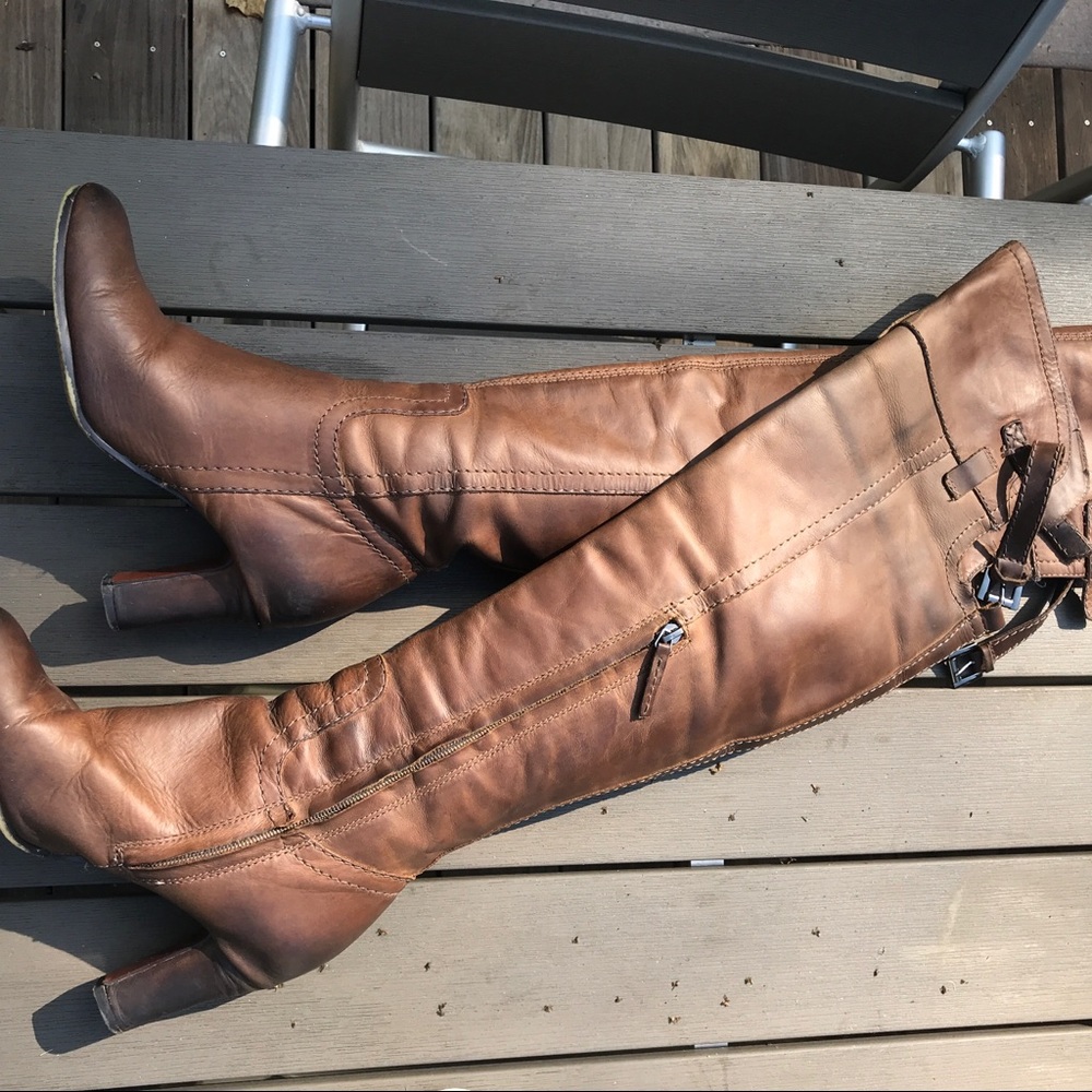 Knee-high brown leather boots with thick heel